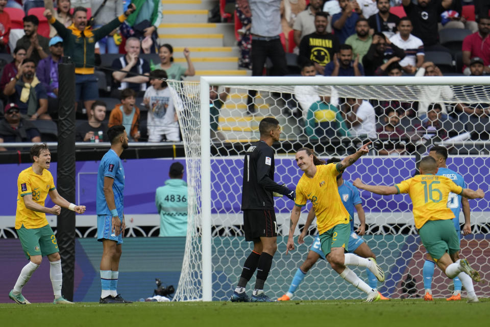 Australia's Jackson Irvine, center, celebrates after scoring the opening goal of his team during the Asian Cup Group B soccer match between Australia and India at Ahmad Bin Ali Stadium in Doha, Qatar, Saturday, Jan. 13, 2024. (AP Photo/Aijaz Rahi)