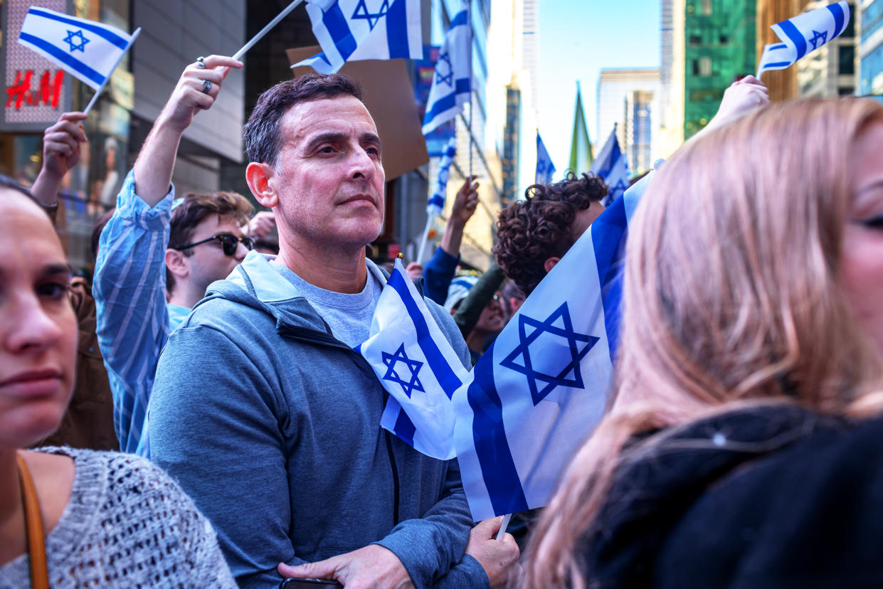 Pro-Israel demonstrators hold flags.