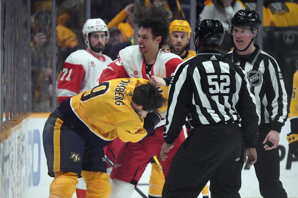 Red Wings defenseman Moritz Seider and Predators left wing Filip Forsberg fight during the second period on Saturday, March 23, 2024, in Nashville, Tennessee.