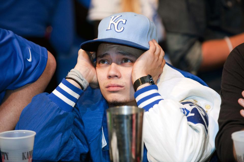 A Kansas City Royals fan reacts to their team's loss at baseball's World Series against the San Francisco Giants, during a watch party at The Kansas City Power & Light District in Kansas City, Missouri, October 29, 2014. REUTERS/Sait Serkan Gurbuz (UNITED STATES - Tags: SPORT BASEBALL)