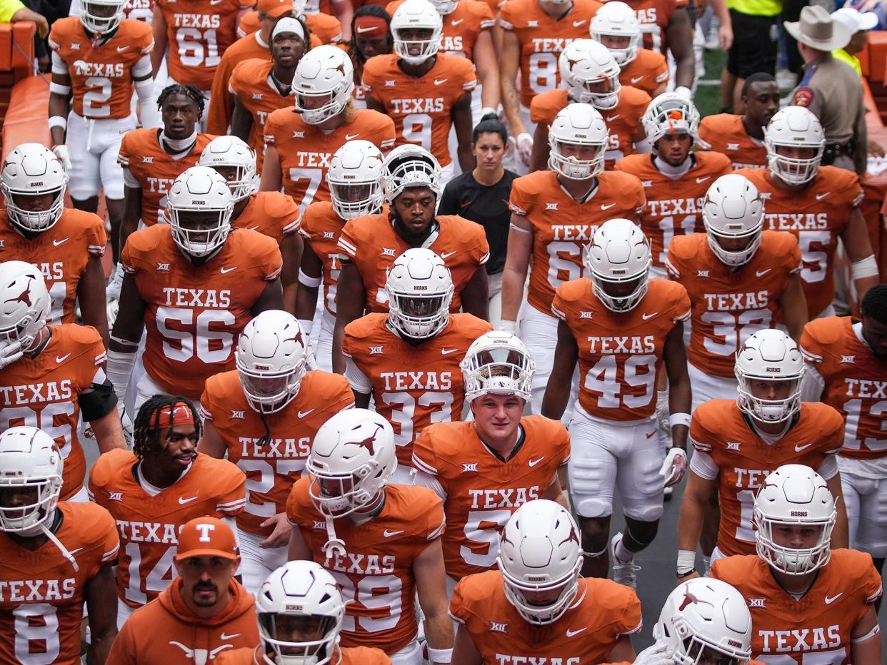 Texas players make their way back to the locker room after warming up for the Nov. 4 overtime win over Kansas State. The Longhorns are 12-1 and Monday night will play in their first College Football Playoff game, a far cry from the program's 5-7 season just two years ago in head coach Steve Sarkisian's debut.