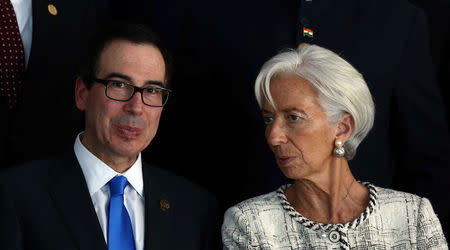 Christine Lagarde, Managing Director of the International Monetary Fund (IMF), talks to U.S. Treasury Secretary Steven Mnuchin as they gather for the official photo at the G20 Meeting of Finance Ministers in Buenos Aires, Argentina, March 19, 2018. REUTERS/Marcos Brindicci