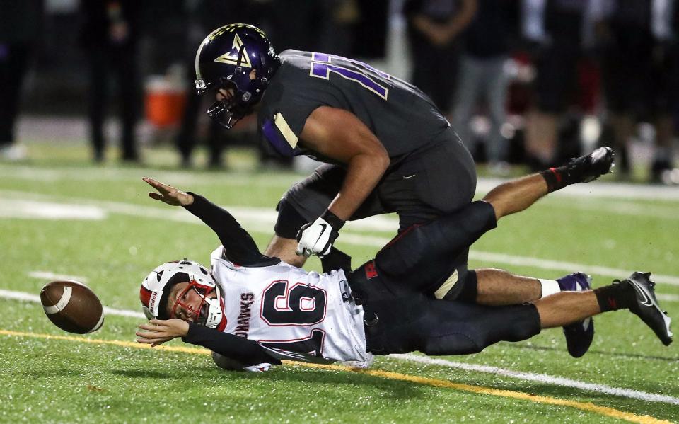 North Kitsap's Sofian Hammou (77) sacks and strips the ball from Renton quarterback Jesse Holmes (16) during the third quarter of their game in Poulsbo, Wash. on Friday, Nov. 4, 2022.