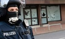 A police officer stands outside a mosque as authorities conduct a search on July 27, 2016 in Hildesheim