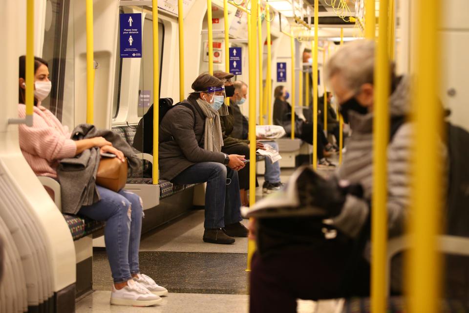 Commuters sit on a District line train on the London underground as England enters a second coronavirus lockdown on November 5, 2020. (Photo by Hollie Adams / AFP) (Photo by HOLLIE ADAMS/AFP via Getty Images)