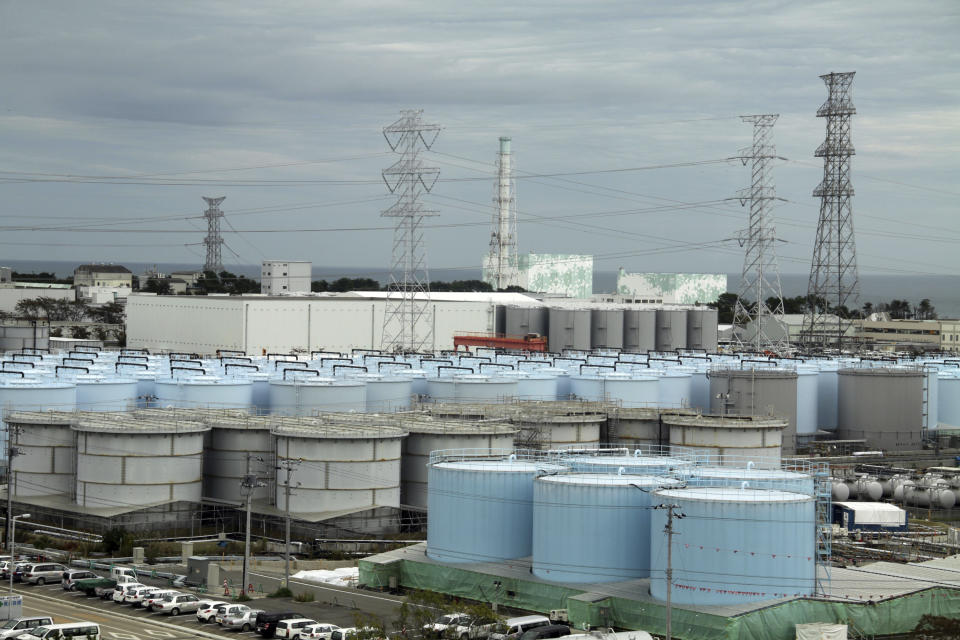 FILE - In this Oct. 12, 2017, file photo, ever-growing amount of contaminated, treated but still slightly radioactive, water at the wrecked Fukushima Dai-ichi nuclear plant is stored in about 900 huge tanks, including those seen in this photo taken during a plant tour at Fukushima Daiichi Nuclear Power Plant in Okuma, Fukushima prefecture, northeast of Tokyo. Japan revised a roadmap on Friday, Dec. 27, 2019, for the tsunami-wrecked Fukushima nuclear plant cleanup, further delaying the removal of thousands of spent fuel units that remain in cooling pools since the 2011 disaster. It's a key step in the decadeslong process, underscoring high radiation and other risks. (Pablo M. Diez/Pool Photo via A, File)