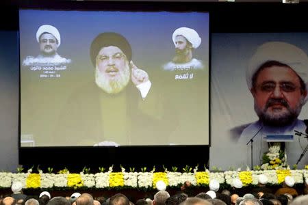 Lebanon's Hezbollah leader Sayyed Hassan Nasrallah addresses his supporters via a screen during a memorial service to mourn the death of Sheikh Mohammad Khatoun who was a member of Hezbollah Central Council, and to condemn the execution of Sheikh Nimr al-Nimr, a Shi'ite cleric who was executed along with others in Saudi Arabia, in Beirut's southern suburbs January 3, 2016. REUTERS/Issam Kobeisi