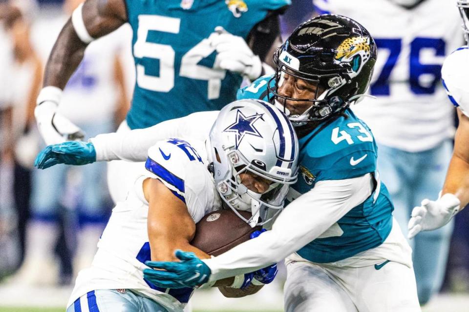 Dallas Cowboys running back Deuce Vaughn (42) gets wrapped up by Jacksonville Jaguars cornerback Kaleb Hayes (43) in the third quarter during the first preseason game between the Dallas Cowboys and Jacksonville Jaguars at AT&T Stadium in Arlington, Texas on Saturday, Aug. 12, 2023. Chris Torres/ctorres@star-telegram.com