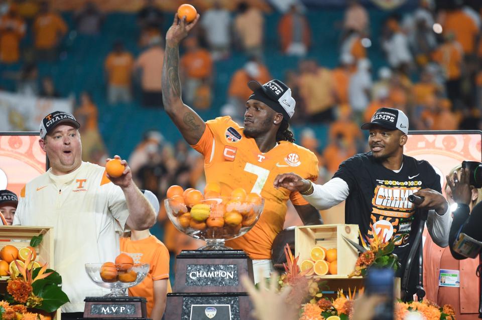 Tennessee head football coach Josh Heupel, Tennessee quarterback Joe Milton III (7), and Tennessee quarterback Hendon Hooker (5) throw oranges to teammates after winning the Orange Bowl game between the Tennessee Vols and Clemson Tigers at Hard Rock Stadium in Miami Gardens, Fla. on Friday, Dec. 30, 2022.