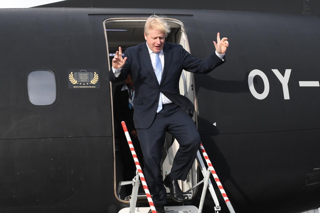 <p>Boris Johnson arrives at Cardiff airport during the 2019 general electiono campaign</p> (PA)