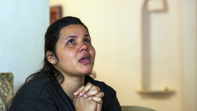 Venezuelan asylum-seeker Oriana Marcano, 29, cries and gives thanks to God for keeping her family safe during the crossing of Panama’s Darien Gap last year, during an interview in El Paso, Texas, on May 12, 2023. “The children were screaming, ‘Mom, my dad!’” she recalls. “My only solution was to get down on my knees — ‘My God, don’t take him from me.’” Once they made it out, they still faced robberies, extortion and pushback across Central America and Mexico.
