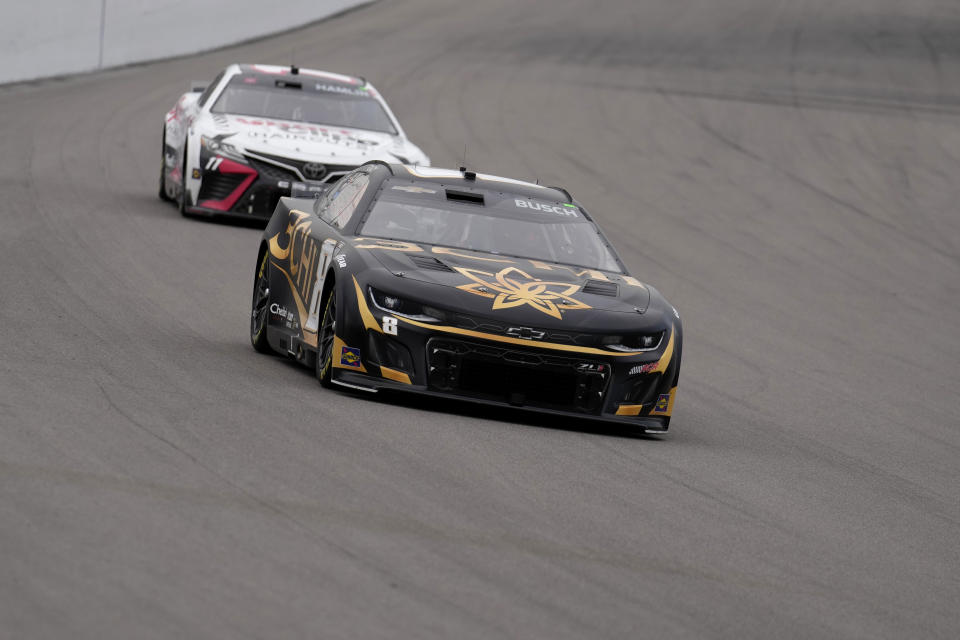 Kyle Busch, front, drives followed by Denny Hamlin (11) during a NASCAR Cup Series auto race at World Wide Technology Raceway, Sunday, June 4, 2023, in Madison, Ill. (AP Photo/Jeff Roberson)