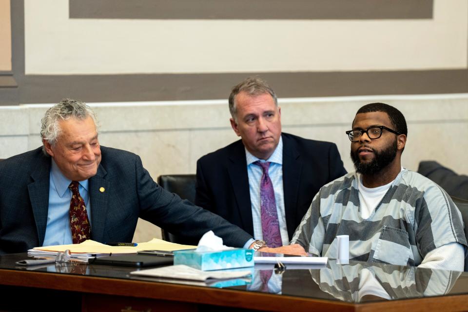Mark Godsey, director of the Ohio Innocence Project, sits between lawyer Marty Pinales and defendant Marcus Sapp, whose 2010 homicide conviction was overturned in January 2023. Hamilton County prosecutors are moving forward with a retrial against Sapp.