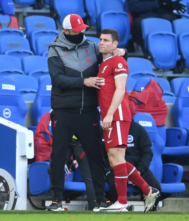 Liverpool’s James Milner, right, is consoled by manager Jurgen Klopp as he is substituted with an injury