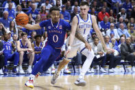 Kansas' Bobby Pettiford Jr. (0) drives on Kentucky's CJ Fredrick (1) during the second half of an NCAA college basketball game in Lexington, Ky., Saturday, Jan. 28, 2023. Kansas won 77-68. (AP Photo/James Crisp)