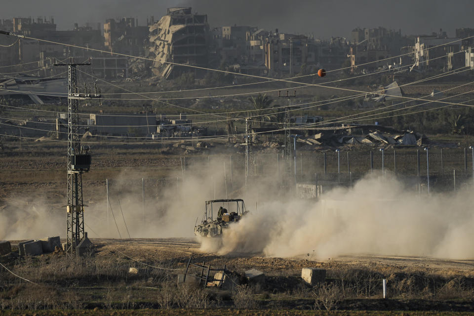 Israeli troops are seen near the Gaza Strip border, in southern Israel, Monday, Dec. 11, 2023. The army is battling Palestinian militants across Gaza in the war ignited by Hamas' Oct. 7 attack into Israel. (AP Photo/Ohad Zwigenberg)