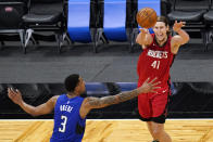 Houston Rockets forward Kelly Olynyk (41) passes the ball over Orlando Magic forward Chuma Okeke (3) during the second half of an NBA basketball game, Sunday, April 18, 2021, in Orlando, Fla. (AP Photo/John Raoux)