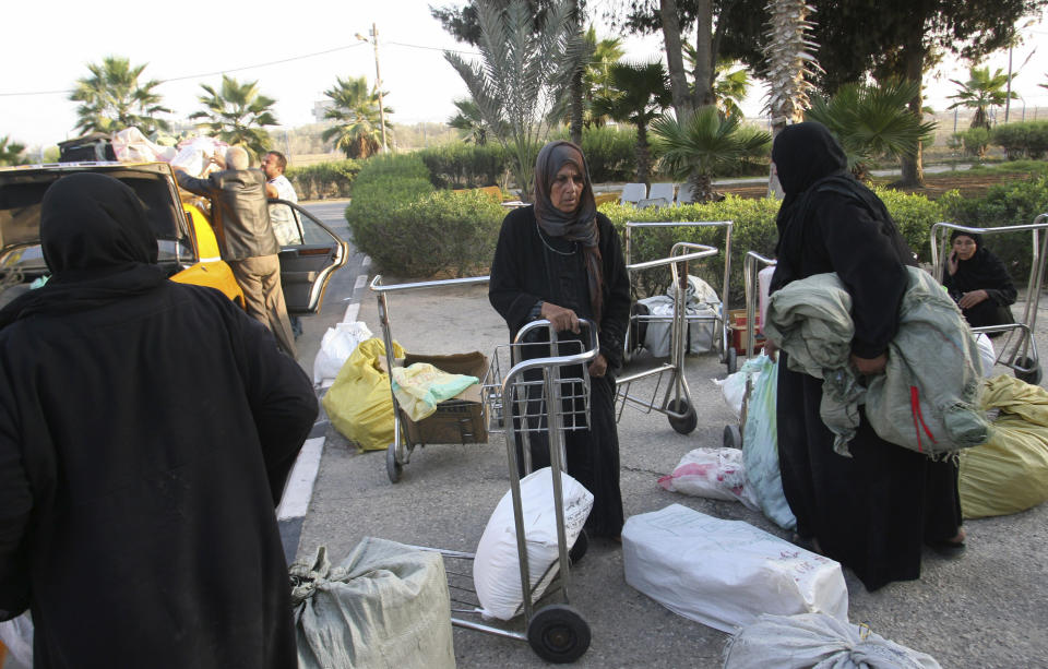 Palestinian women arrive in Rafah after crossing into Gaza Strip from Egypt, Tuesday, Nov. 20, 2012. The $1.4 million terminal reflects a sign of Palestinian hopes that the fighting over the past week will end with a deal leading to an easier flow of people and goods into Egypt, which would transform their lives in the impoverished territory. It would also give Hamas a major victory that could help the Islamic group tighten its grip over Gaza's 1.7 million residents. (AP Photo/Eyad Baba)
