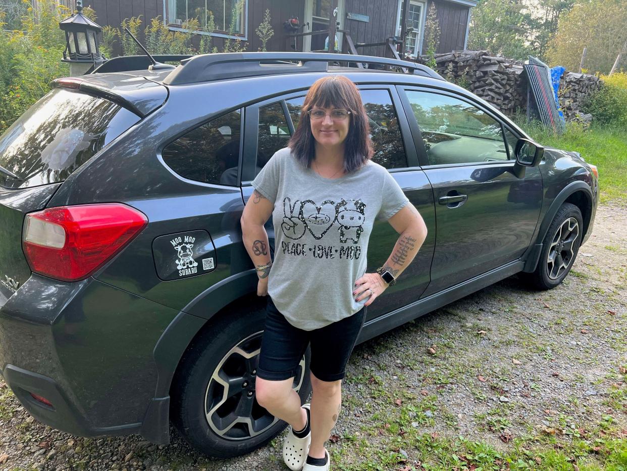 Staci Huckins of Troy, New Hampshire, stands with her Subaru Crosstrek, which she calls "Bella." Huckins started the Moo Moo Subaru Facebook group after a conversation with her friend, Crystal Hamann, about Jeep ducking.