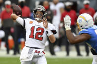 Tampa Bay Buccaneers quarterback Tom Brady (12) throws a pass as he is pressured by Los Angeles Chargers defensive tackle Jerry Tillery (99) during the first half of an NFL football game Sunday, Oct. 4, 2020, in Tampa, Fla. (AP Photo/Jason Behnken)