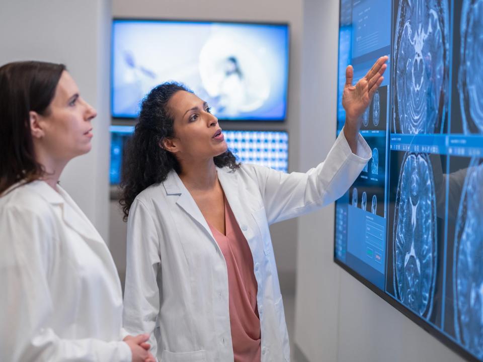 Two doctors consult over an MRI scan