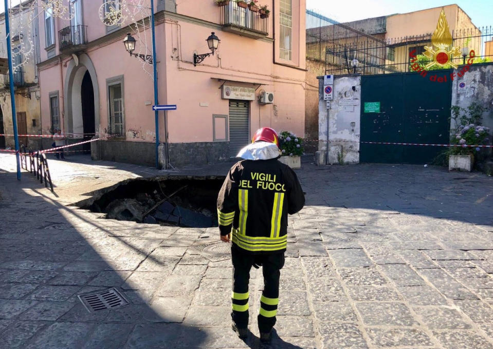 Firefighter surveys the scene after authorities cordon off the area.