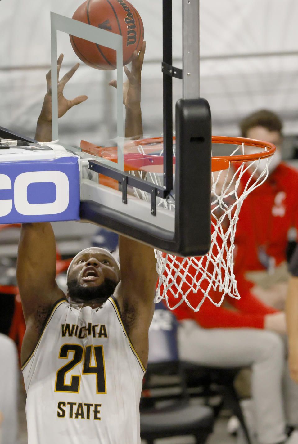 Wichita State forward Morris Udeze (24) goes up for a pass above the rim against Cincinnati during the first half of an NCAA college basketball game in the semifinal round of the American Athletic Conference men's tournament Saturday, March 13, 2021, in Fort Worth, Texas. (AP Photo/Ron Jenkins)