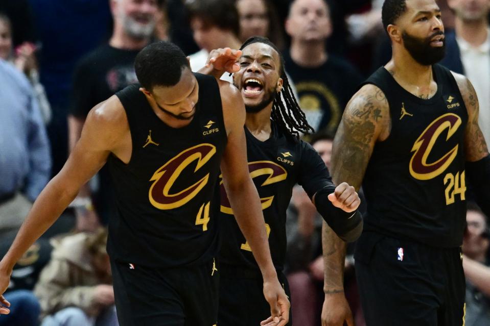 Cavaliers guard Darius Garland (middle) celebrates with forward Evan Mobley (4) after Mobley blocked the shot of Magic forward Franz Wagner to seal the win in Game 5 of a first-round NBA playoff series, April 30, 2024, in Cleveland.