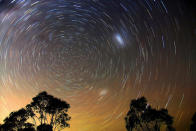 As the Earth rotates during the 30-minute exposure of this photograph the stars make trails around the sky’s south pole. Taken in Australia, the Large and Small Magellanic Clouds, two neighbouring galaxies, appear as faint blurs in the sky. An equivalent photograph taken from Britain would show Polaris (the Pole Star) at the centre of the star trails. Ted Dobosz was the Winner of the ‘Earth and Space’ category, Astronomy Photographer of the Year, 2009 (Star Trails, Blue Mountains © Ted Dobosz, 2009)