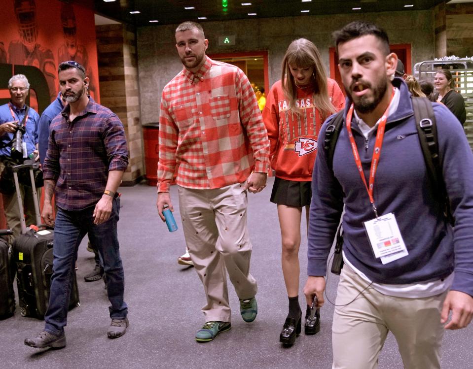 Chiefs tight end Travis Kelce, center left, and singer Taylor Swift leave Arrowhead stadium together after an October game.