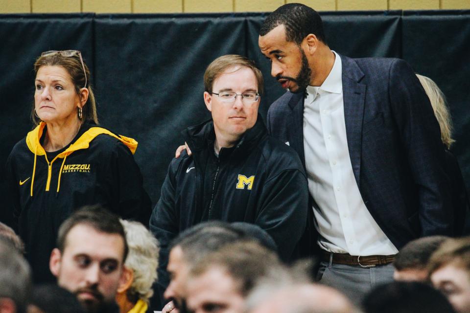 Missouri head football coach Eli Drinkwitz listens as Tigers basketball alum Laurence Bowers says something in his ear during Dennis Gates' introductory press conference March 22 at Mizzou Arena.