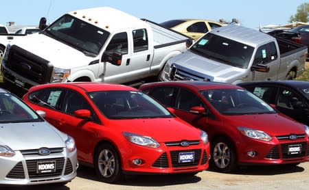 FILE PHOTO: A row of Ford Focus are displayed next to Ford F-Series pickups at Koons Ford in Silver Spring