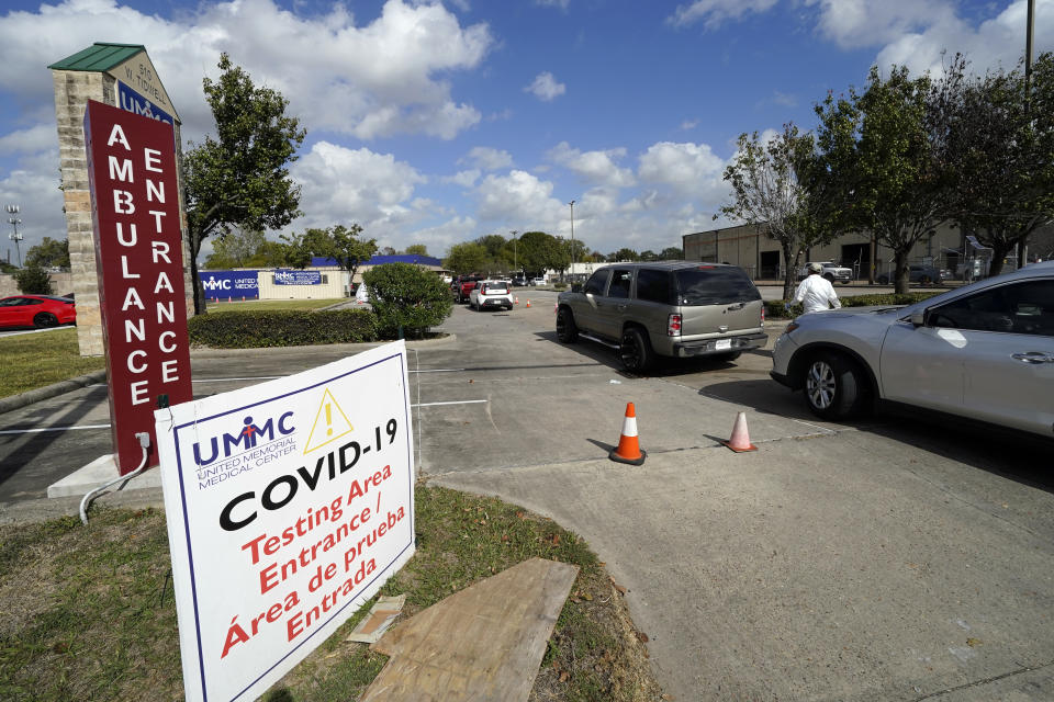 Drivers wait in line at a United Memorial Medical Center COVID-19 testing site Thursday, Nov. 19, 2020, in Houston. (AP Photo/David J. Phillip)