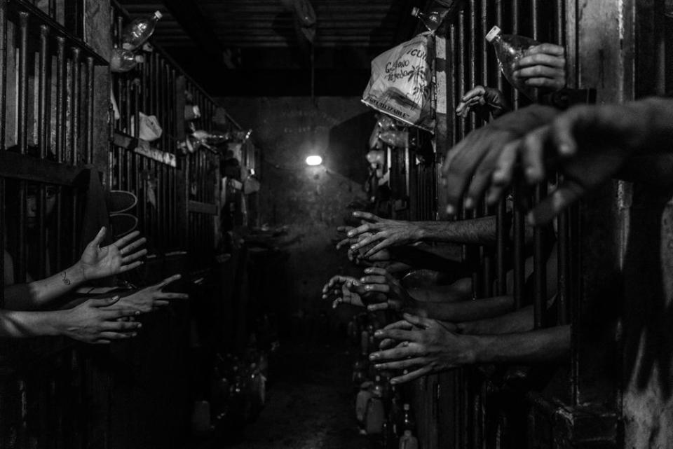 Prisoners beg for food and water while being detained at a municipal police station in Caracas.