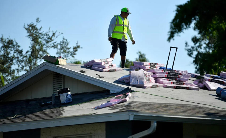 Tony Ochoa, of Strong Roofing, works at a home in Sarasota Springs in this October 3, 2023, file photo. In Sarasota County, unlike other nearby jurisdictions, a new roof comes with another cost: a higher tax bill. Other area counties' elected property appraisers consider replacing a roof with the same material to be a maintenance issue, but Sarasota County's Property Appraiser classifies it as a capital improvement that enhances the home's taxable value.