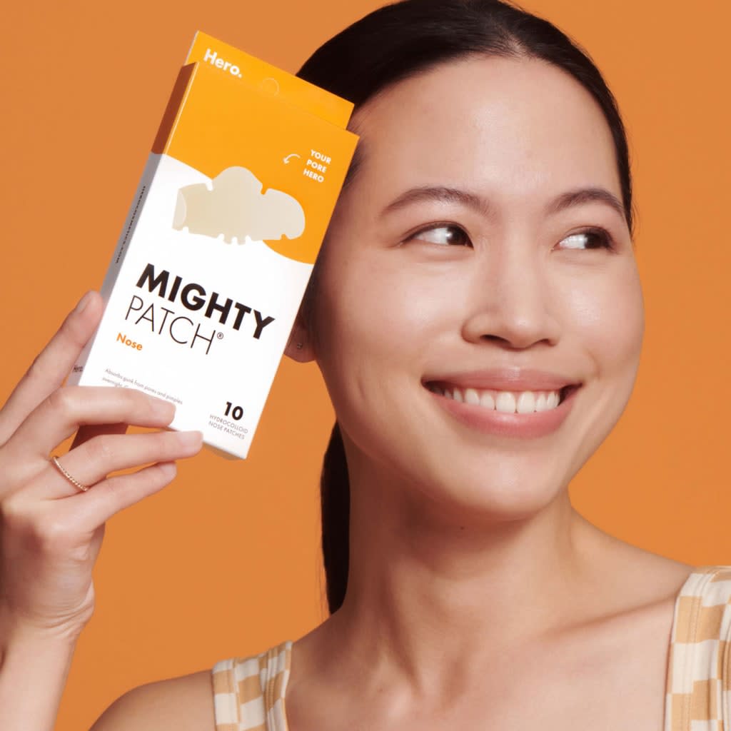 Woman holding Mighty Patch nose strips (Photo: Amazon)