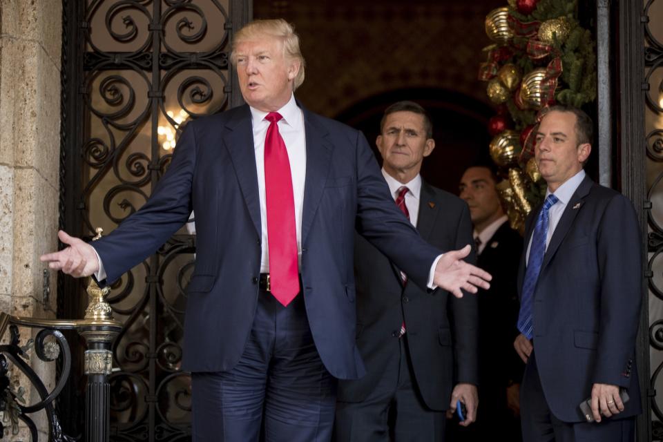 President-elect Donald Trump, left, accompanied by then RNC Chairman Reince Priebus, right, and retired Gen. Michael Flynn, center, speaks to members of the media at Mar-a-Lago in Palm Beach, Fla., on Dec. 21, 2016. (Photo: Andrew Harnik/AP)