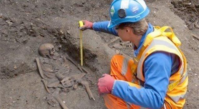 A Crossrail archaeologist uncovering a skeleton found in a tunnel shaft in London. Thirteen skeletons thought to be victims of the Black Death plague which swept Britain over 600 years ago have been dug up by workers on the '15 billion Crossrail project in London. Photo: AFP.