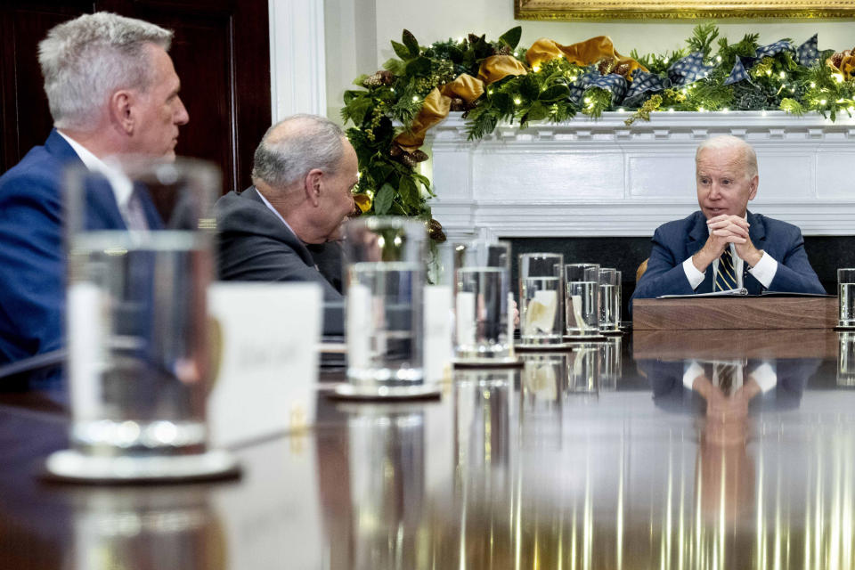 FILE - President Joe Biden, right, speaks at the top of a meeting with congressional leaders to discuss legislative priorities for the rest of the year, Nov. 29, 2022, in the Roosevelt Room of the White House in Washington, as House Minority Leader Kevin McCarthy of Calif., Senate Majority Leader Chuck Schumer, of N.Y. House Speaker Kevin McCarthy said Sunday, Jan. 29, 2023, that he is looking forward to discussing with Biden a “reasonable and responsible way to lift the debt ceiling” when the two meet for their first sit-down on Wednesday with McCarthy as leader of the chamber. (AP Photo/Andrew Harnik, File)