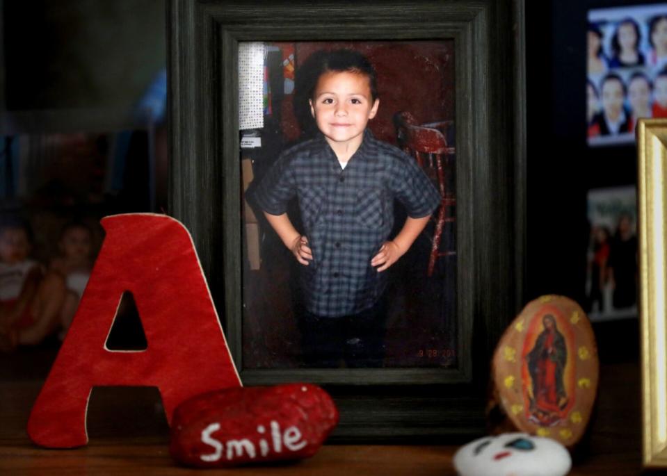 A photo of Anthony Avalos - a slightly smiling boy in a checkered shirt with his hands on his hips.