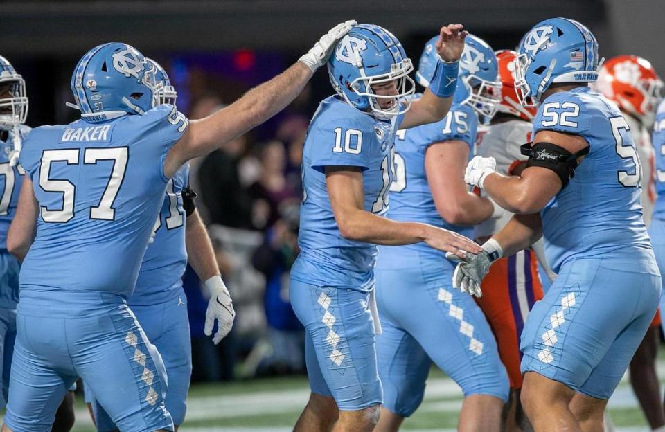 North Carolina quarterback Drake Maye (10) and his teammates react after scoring a touchdown on a three-yard run in the first quarter during the ACC Championship game against Clemson on Saturday, December 3, 2022 at Bank of American Stadium in Charlotte, N.C.