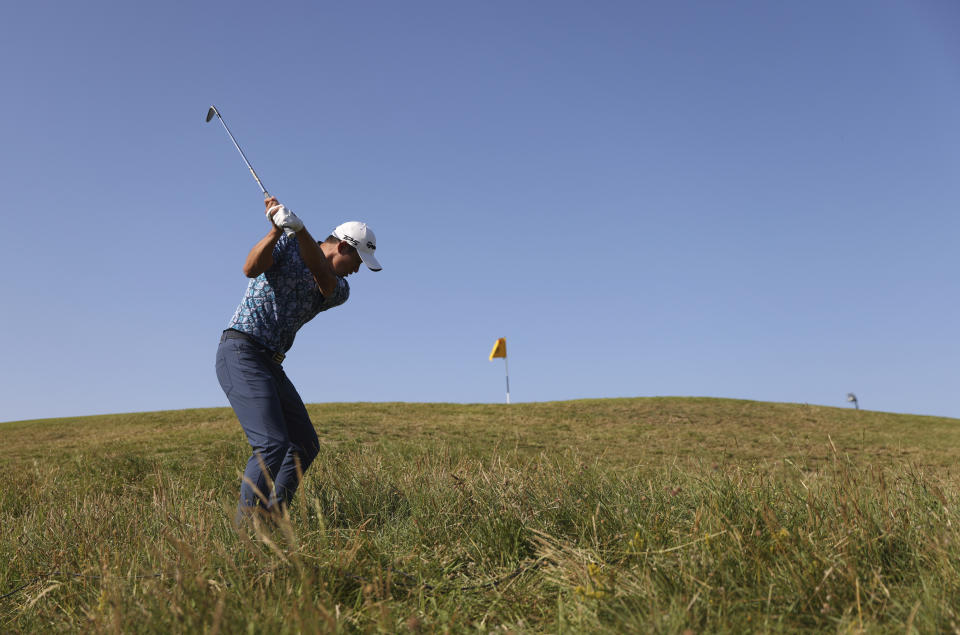 United States' Collin Morikawa plays a shot on the 10th from the rough during the final round of the British Open Golf Championship at Royal St George's golf course Sandwich, England, Sunday, July 18, 2021. (AP Photo/Peter Morrison)