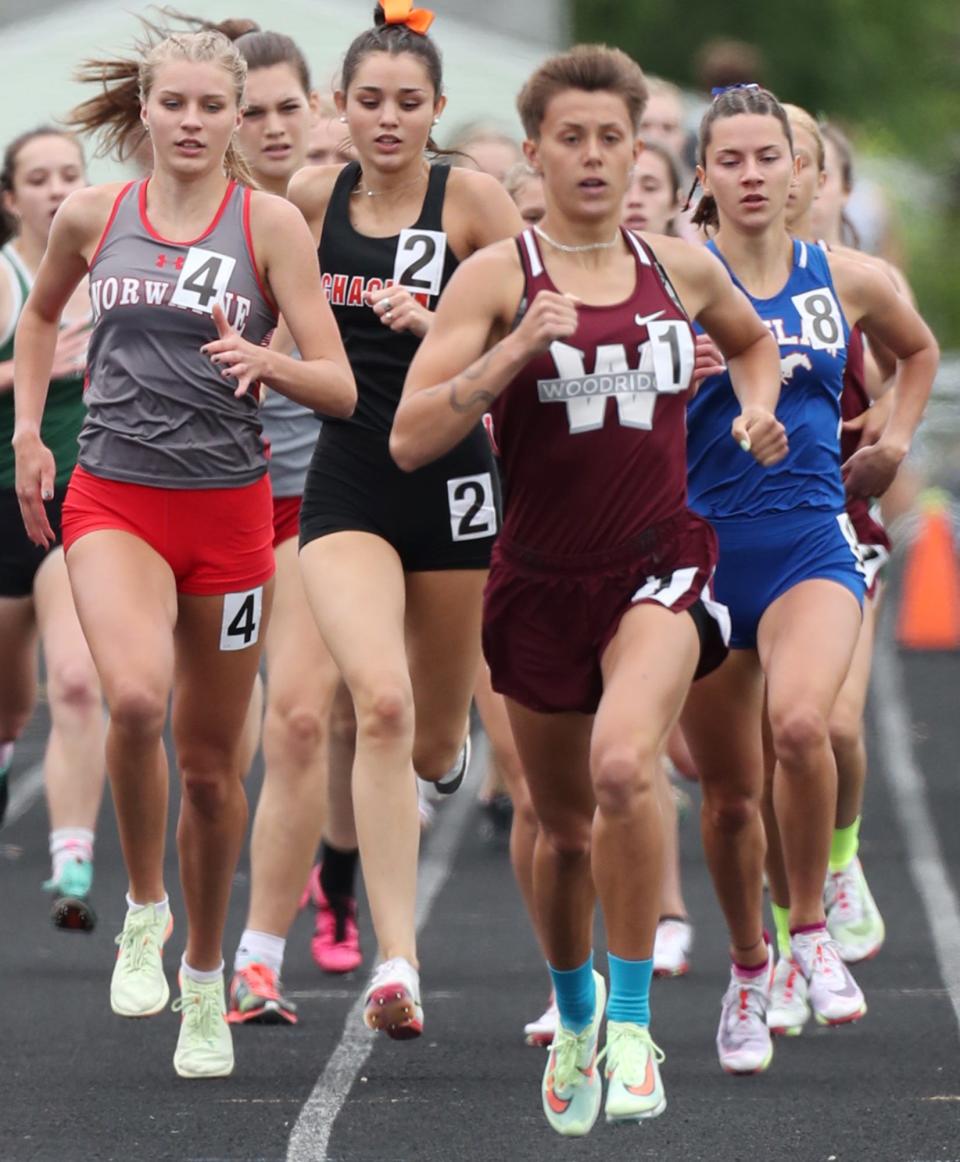 Norwayne's Jaylee Wingate, left and Tuslaw's Malena Cybak, right, follow  Woodrige's Izzy Best, center,  compete during the girls 800 meter run at Austintown Fitch High School on Saturday. Norwayne's Wingate took first, Tuslaw's Cybak place second and Woodridge's Best finished third in the event.