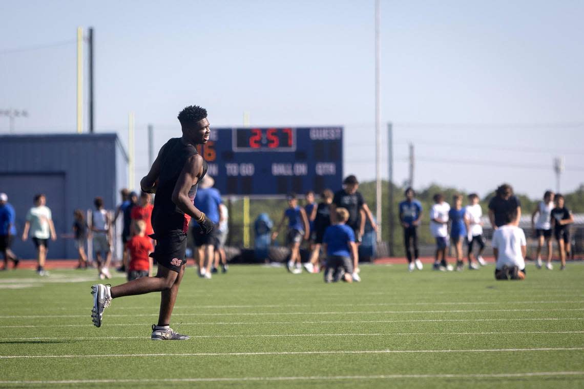 A player runs an offensive drill during freshman football camp at Midlothian High School on Thursday, July 28, 2022.