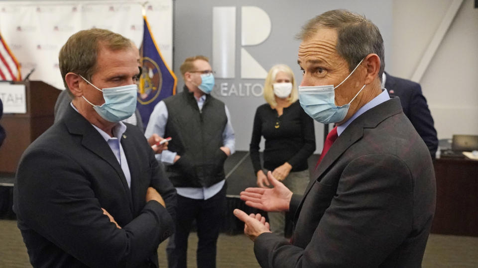 FILE - In this Nov. 3, 2020, file photo, Republican Reps. Chris Stewart, left, and John Curtis talk during an Utah Republican election night party in Sandy, Utah. Curtis is leading a new Conservative Climate Caucus for House Republicans. The group wants to educate fellow Republicans about global warming and develop market-based policies to counter Green New Deal and other Democratic proposals. (AP Photo/Rick Bowmer, File)