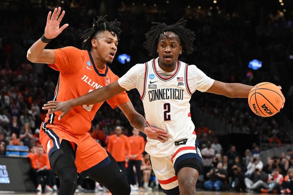 Mar 30, 2024; Boston, MA, USA; Connecticut Huskies guard Tristen Newton (2) dribbles the ball Illinois Fighting Illini guard Terrence Shannon Jr. (0) n the finals of the East Regional of the 2024 NCAA Tournament at TD Garden. Mandatory Credit: Brian Fluharty-USA TODAY Sports