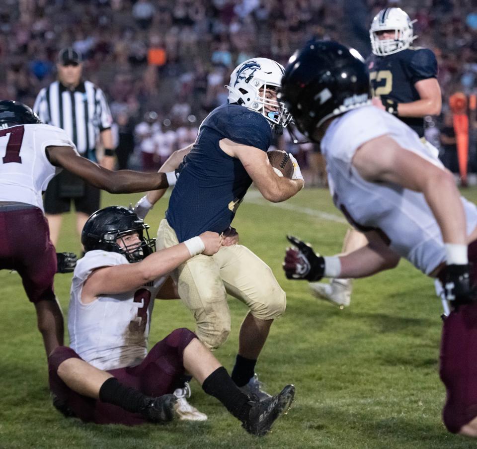 Evan Hernandez (3) is taken down by Vinny Villanova (3) but not before he picks up the first down during the Navarre vs Gulf Breeze spring football game at Gulf Breeze High School on Friday, May 19, 2023.