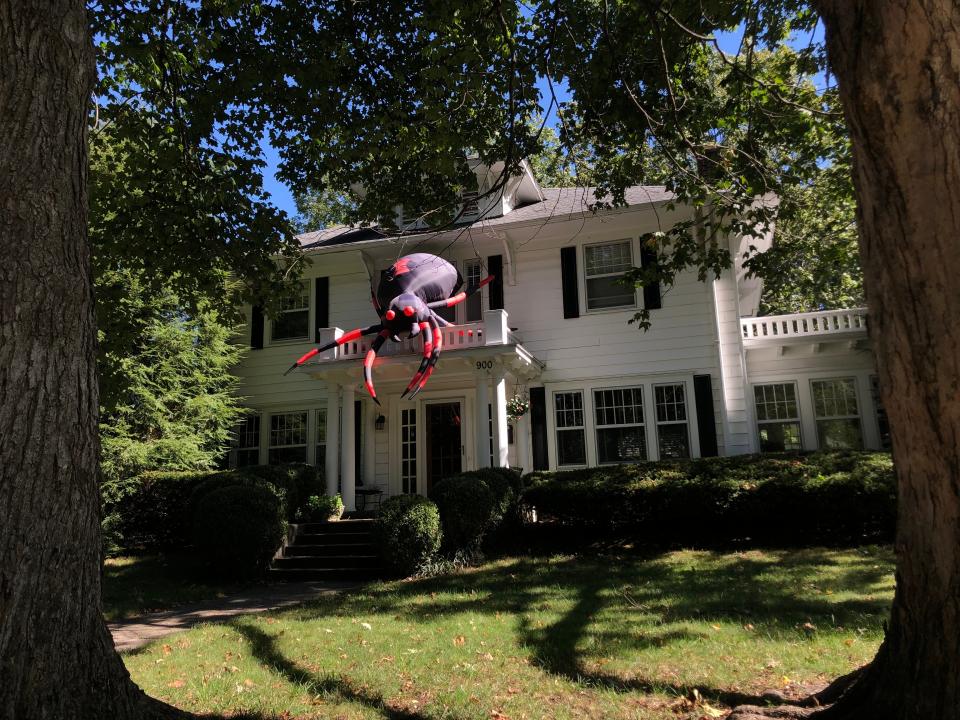 An inflatable spider sits on the roof of the home at 900 S. Pickwick Ave. on Sunday, Oct. 8, 2023.