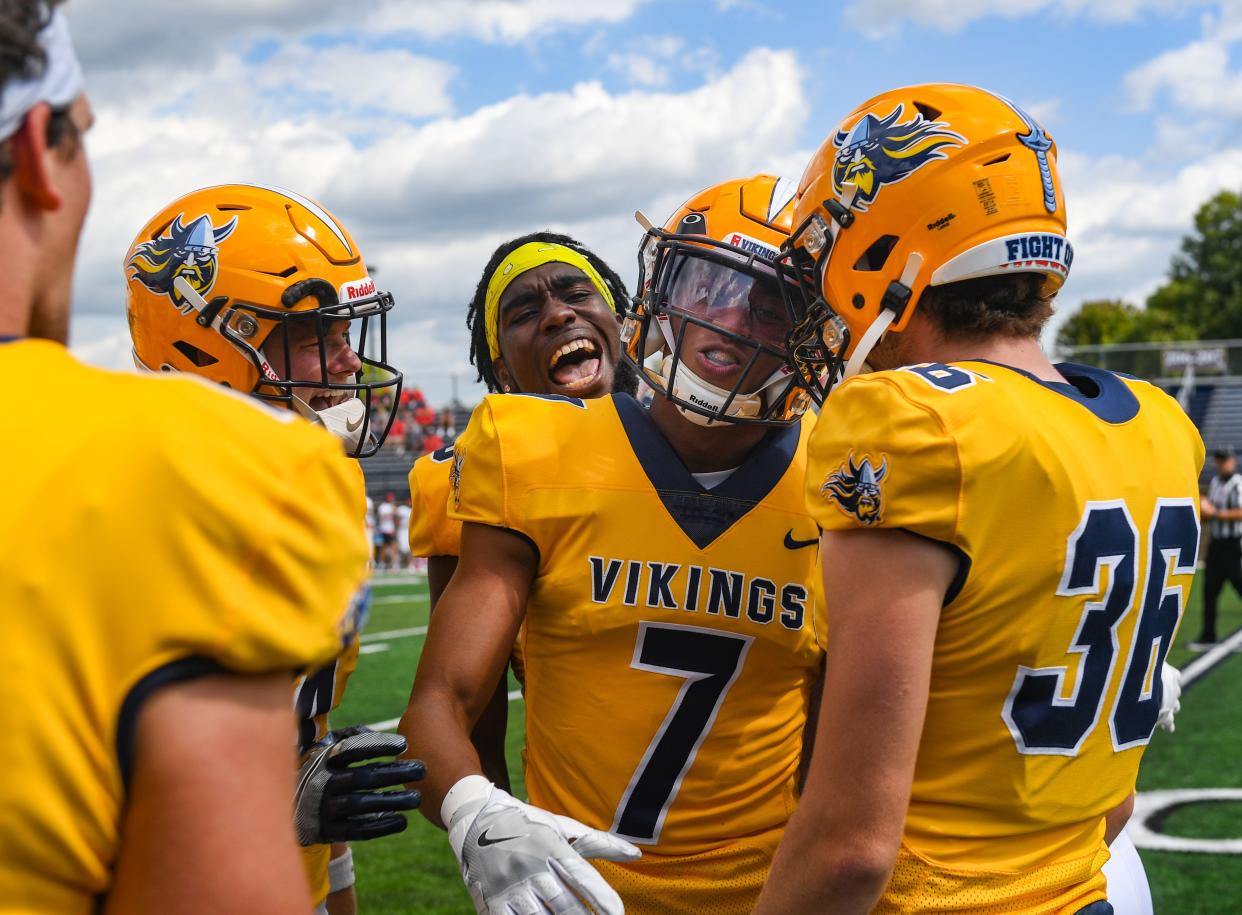 Augustana players celebrate a successful defensive play by Sydney Capers, center, that prevented a Minot State touchdown in their first home football game of the season on Saturday, September 4, 2021 at Kirkeby-Over Stadium in Sioux Falls.