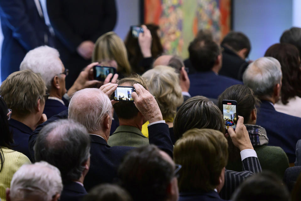 Attendees take photographs of the painting 'Portrait of Fräulein Lieser' by Austrian painter Gustav Klimt during an auction, in Vienna, Wednesday, April 24, 2024. A portrait of a young woman by Gustav Klimt that was long believed to be lost has been sold at an auction in Vienna for 30 million euros ($32 million). The Austrian modernist artist started work on the “Portrait of Fräulein Lieser” in 1917, the year before he died, and it is one of his last works. (AP Photo/Christian Bruna)